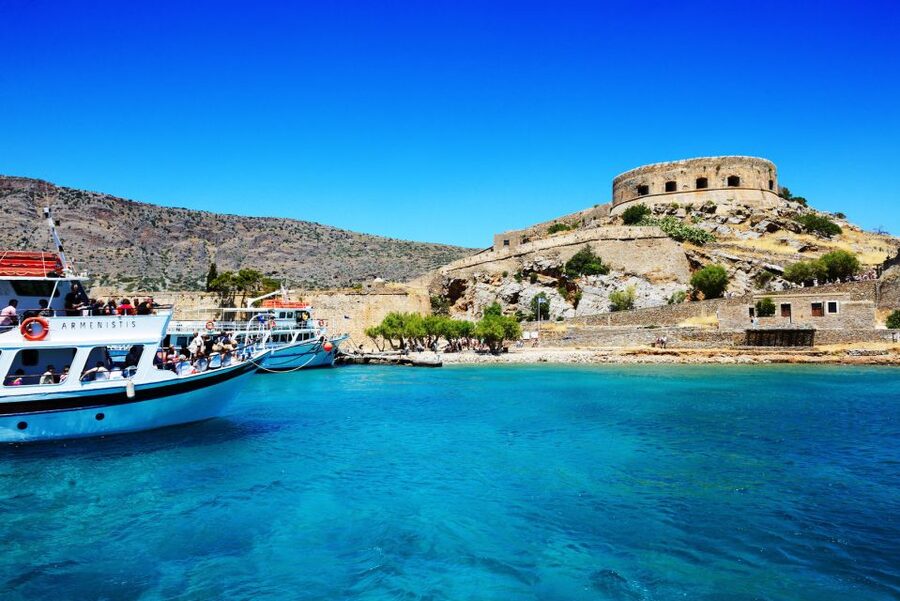 Elounda: Spinalonga Guided Boat Tour with BBQ and Swimming - The Spinalonga walking tour: fortress views with layered history