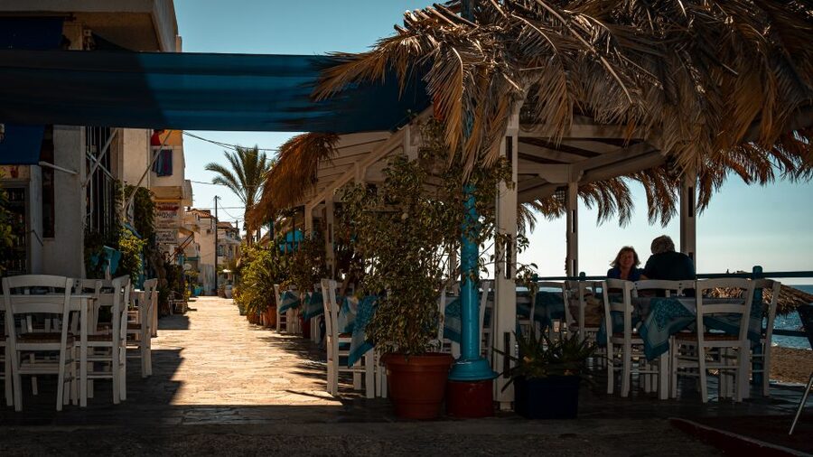 From Heraklion: Kritsa & Myrtos Villages East & South Crete - Myrtos Beach: gray sand, clear water, and where taverns fit in